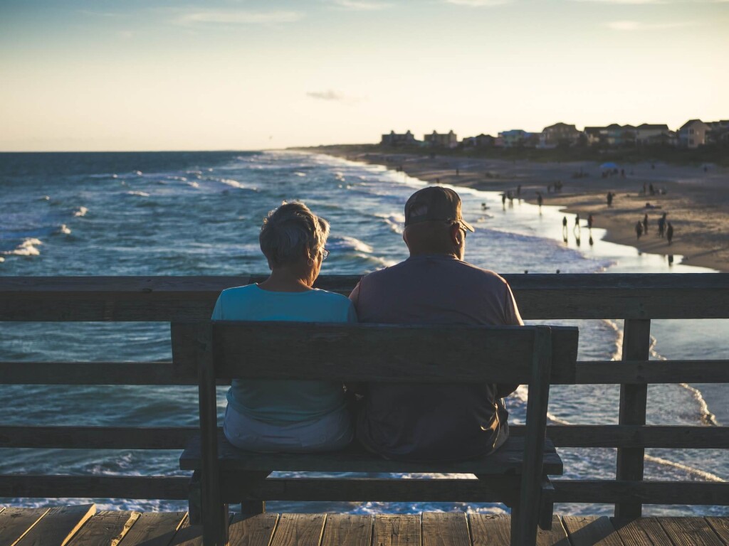 Couple on pier overlooking beach