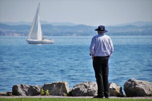 Senior watching sailboat planning for retirement strategies in 2021